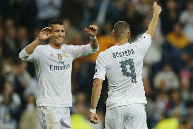 Real Madrid's Karim Benzema, right, celebrates with his teammate Cristiano Ronaldo after scoring during a Group A Champions League soccer match between Real Madrid and Shakhtar Donetsk at the Santiago Bernabeu stadium in Madrid, Spain, Tuesday, Sept. 15, 2015. (AP Photo/Paul White)