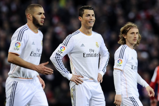 Real Madrid's Cristiano Ronaldo of Portugal, center, gestures beside his fellow teammate Karim Benzema of France, left, and Luka Modric of Croatia, after he was sent off during their Spanish League soccer match against Athletic Bilbao, at San Mames stadium in Bilbao, Spain, Sunday, Feb. 2, 2014. (AP Photo/Alvaro Barrientos)