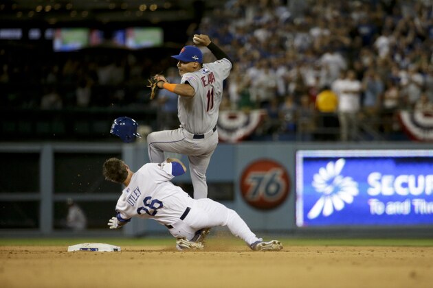 New York Mets shortstop Ruben Tejada, goes over the top of Los Angeles Dodgers' Chase Utley who broke up a double play during the seventh inning in Game 2 of baseball's National League Division Series, Saturday, Oct. 10, 2015 in Los Angeles. (AP Photo/Gregory Bull)