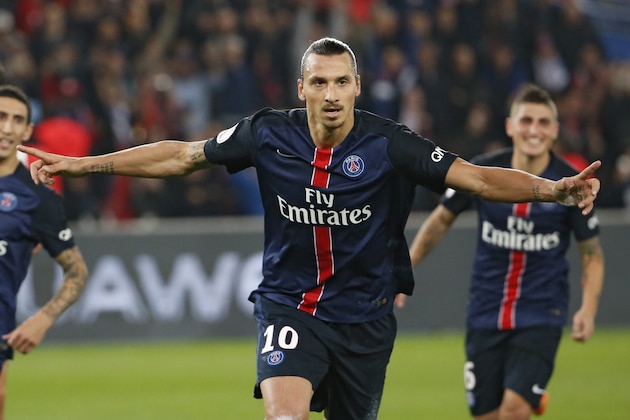 Paris Saint-Germain's Swedish forward Zlatan Ibrahimovic (C) celebrates after scoring a penatly during the French L1 football match Paris Saint-Germain (PSG) vs Olympique de Marseille (OM) on October 4, 2015 at the Parc des Princes stadium in Paris.  AFP PHOTO / THOMAS SAMSON        (Photo credit should read THOMAS SAMSON/AFP/Getty Images)
