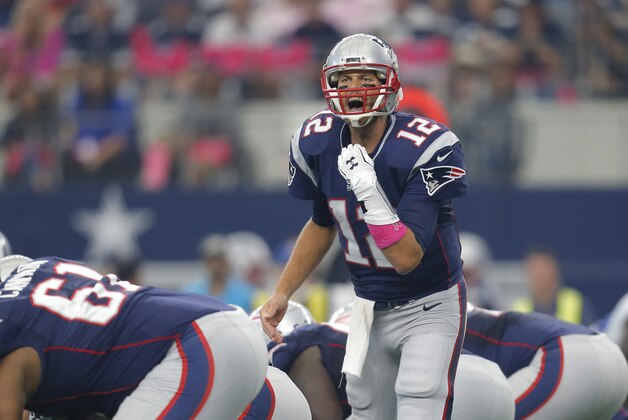 New England Patriots' Tom Brady (12) calls a play during the first quarter of an NFL football game against the Dallas Cowboys, Sunday, Oct. 11, 2015, in Arlington, Texas. (AP Photo/Brandon Wade)