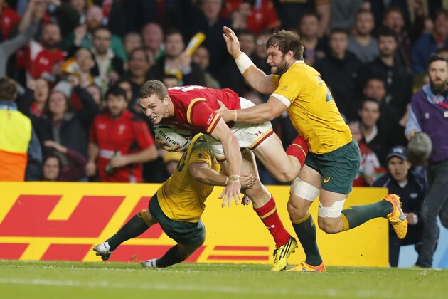 Wales' George North is tackled during the Rugby World Cup Pool A match between Australia and Wales at Twickenham Stadium, London, Saturday, Oct. 10, 2015. (AP Photo/Frank Augstein)