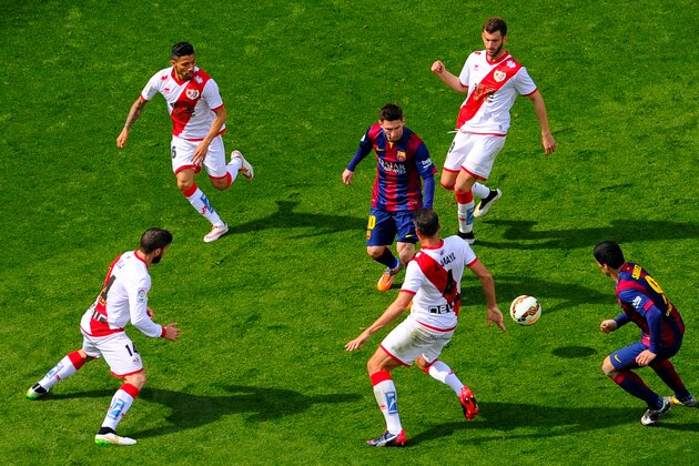 BARCELONA, SPAIN - MARCH 08:  Lionel Messi of FC Barcelona competes for the ball among Rayo Vallecano de Madrid players during the La Liga match between FC Barcelona and Rayo Vallecano de Madrid at Camp Nou on March 8, 2015 in Barcelona, Spain.  (Photo by David Ramos/Getty Images)