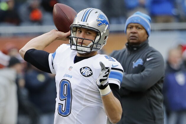 Detroit Lions quarterback Matthew Stafford (9) warms up as head coach Jim Caldwell watches him before an NFL football game against the Chicago Bears Sunday, Dec. 21, 2014, in Chicago. (AP Photo/Charles Rex Arbogast)