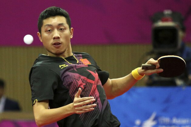 China's Xu Xin plays against compatriots Ma Long and Zhang Jike during the table tennis men's doubles gold medal match at the 17th Asian Games in Incheon, South Korea,  Friday, Oct. 3, 2014. (AP Photo/Rob Griffith)