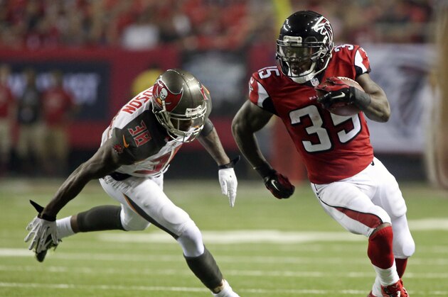 Sep 18, 2014; Atlanta, GA, USA; Atlanta Falcons running back Antone Smith (35) scores a touchdown past Tampa Bay Buccaneers free safety Dashon Goldson (38) in the third quarter of their game at the Georgia Dome. The Falcons won 56-14. Mandatory Credit: Jason Getz-USA TODAY Sports