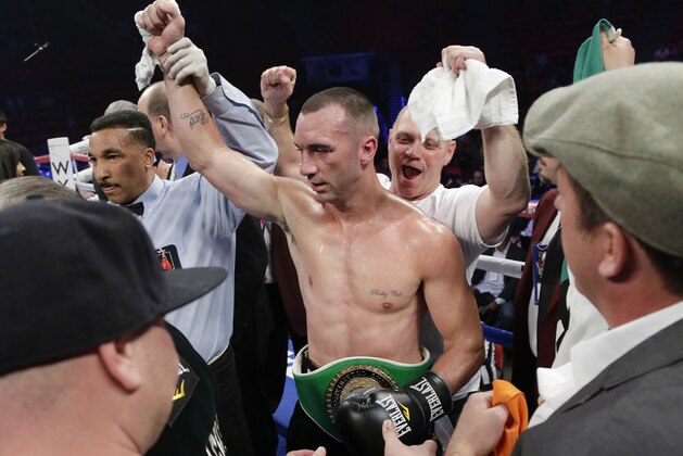Sean Monaghan, center, is declared the winner by referee Tony Weeks after defeating Anthony Caputo-Smith in the third round during a light heavyweight fight, Saturday, Oct. 12, 2013, in Las Vegas. (AP Photo/Julie Jacobson)