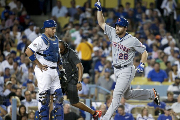 New York Mets' Daniel Murphy celebrates a solo home run as Los Angeles Dodgers catcher A.J. Ellis looks down during the fourth inning in Game 1 of baseball's National League Division Series, Friday, Oct. 9, 2015 in Los Angeles. (AP Photo/Gregory Bull)
