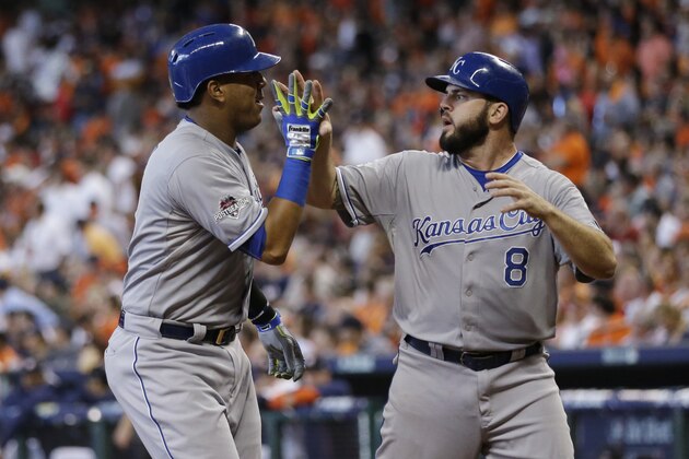 Kansas City Royals' Salvador Perez (13) celebrates with teammate Mike Moustakas, right, after hitting a two-run home run against the Houston Astros in the second inning during Game 4 of baseball's American League Division Series Monday, Oct. 12, 2015, in Houston. (AP Photo/David J. Phillip)
