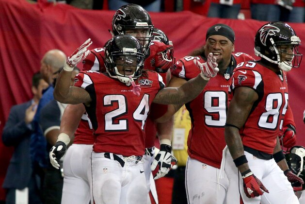 Oct 11, 2015; Atlanta, GA, USA; Atlanta Falcons running back Devonta Freeman (24) celebrates his rushing touchdown with teammates in the fourth quarter of their game against the Washington Redskins at the Georgia Dome. The Falcons won 25-19 in overtime. Mandatory Credit: Jason Getz-USA TODAY Sports