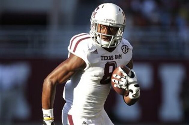 FILE - In this Nov. 10, 2012, file photo, Texas A&M wide receiver Thomas Johnson (8) carries for extra yardage after a reception during the first half of an NCAA college football game against Alabama in Tuscaloosa, Ala. Johnson has been found safe in Dallas after he disappeared from campus days ago. Johnson's mother, Linda Hanks, says A&M University police told her Thursday, Nov. 15, 2012, the 18-year-old is unharmed. (AP Photo/Dave Martin, File)