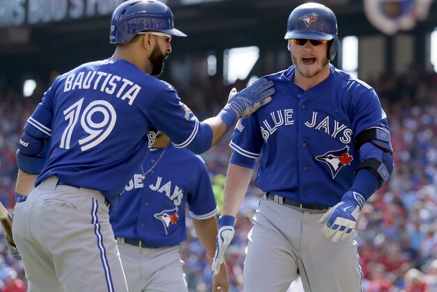 Toronto Blue Jays third baseman Josh Donaldson, right, celebrates his two-run home run with right fielder Jose Bautista (19) during the first inning in Game 4 of baseball's American League Division Series against the Texas Rangers, Monday, Oct. 12, 2015, in Arlington, Texas. (AP Photo/LM Otero)