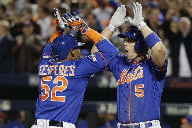 New York Mets' David Wright (5) greets Yoenis Cespedes (52) after Cespedes hit a two run home run against the Los Angeles Dodgers during the fourth inning of baseball's Game 3 of the National League Division Series, Monday, Oct. 12, 2015, in New York. (AP Photo/Julie Jacobson)