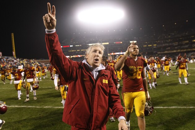Southern California head coach Pete Carroll, foreground, celebrates a win over Boston College in the Emerald Bowl NCAA college football game in San Francisco, Saturday, Dec. 26, 2009. USC won 24-13. (AP Photo/Marcio Jose Sanchez)