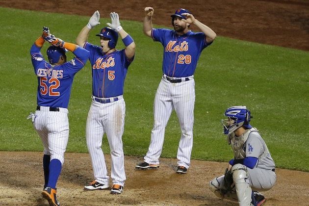 New York Mets' Yoenis Cespedes (52) celebrates with David Wright (5) and Daniel Murphy (28) after hitting a three-run home run during the fourth inning as Los Angeles Dodgers catcher Yasmani Grandal watches them in Game 3 of baseball’s National League Division Series, Monday, Oct. 12, 2015, at CitiField in New York. (AP Photo/Frank Franklin II)