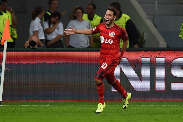Leverkusen's midfielder Hakan Calhanoglu celebrates scoring during the UEFA Champions League playoff football match between Bayer Leverkusen and SS Lazio, in Leverkusen, western Germany, on August 26, 2015.  AFP PHOTO / PATRIK STOLLARZ        (Photo credit should read PATRIK STOLLARZ/AFP/Getty Images)