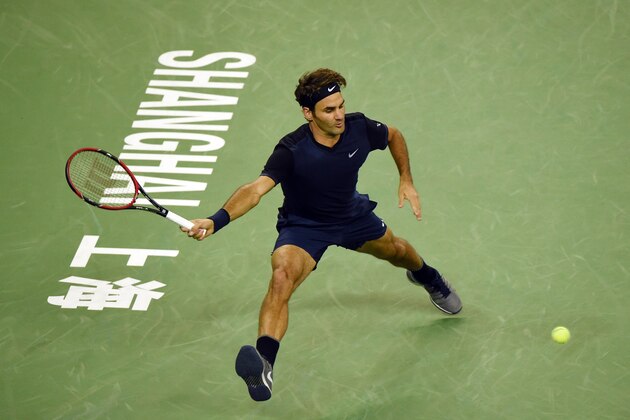 Roger Federer of Switzerland hits a return during his men's singles second round match against Albert Ramos-Vinolas of Spain at the Shanghai Masters tennis tournament in Shanghai on October 13, 2015. AFP PHOTO / GREG BAKER        (Photo credit should read GREG BAKER/AFP/Getty Images)