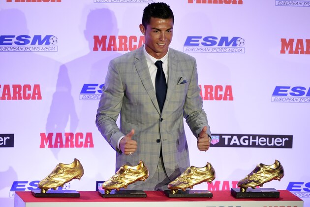 Real Madrid's Portuguese forward Cristiano Ronaldo poses with his European Golden Shoes after receiving the fourth one, on October 13, 2015 in Madrid. Cristiano, who ended the season with 48 goals from 35 appearances, won the Golden Shoe in 2008 while he was at Manchester United, in 2011 with Real Madrid and shared it with Luis Suarez last year. AFP PHOTO / JAVIER SORIANO        (Photo credit should read JAVIER SORIANO/AFP/Getty Images)