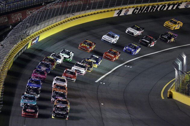 Cars exit Turn 4 to start the NASCAR Xfinity Series auto race at Charlotte Motor Speedway, Friday, Oct. 9, 2015, in Concord, N.C. (AP Photo/Gerry Broome)