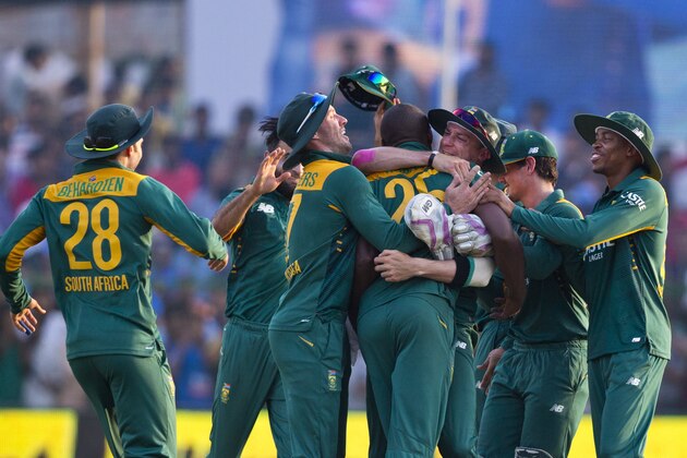 South African cricketers surround Kagiso Rabada, center, who took crucial wickets of India to swing the match towards South Africa in the last few overs during the first one day international cricket match between them in Kanpur, India, Sunday, Oct. 11, 2015. South Africa won by 5 runs. (AP Photo/Saurabh Das)