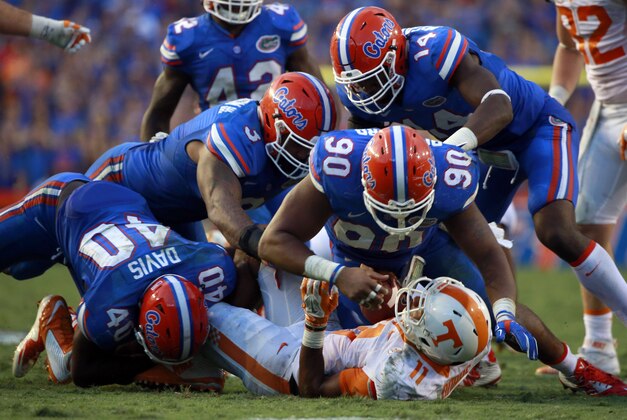 Sep 26, 2015; Gainesville, FL, USA; Florida Gators linebacker Jarrad Davis (40), defensive lineman Jonathan Bullard (90), linebacker Antonio Morrison (3) and defensive lineman Alex McCalister (14) tackle Tennessee Volunteers quarterback Joshua Dobbs (11)  during the second half at Ben Hill Griffin Stadium. Florida Gators defeated the Tennessee Volunteers 28-27. Mandatory Credit: Kim Klement-USA TODAY Sports