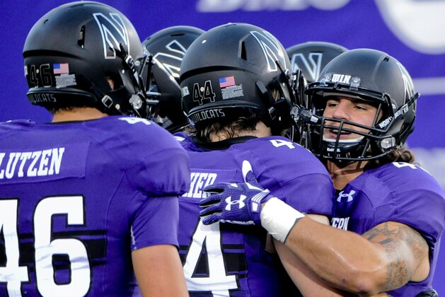 Northwestern fullback Dan Vitale (40)  and Northwestern Wildcats defensive lineman James Prather, second from left, before an NCAA college football game against Ball State Cardinals in Evanston, Ill.,  Saturday, Sept. 26, 2015.   (AP Photo/Matt Marton)