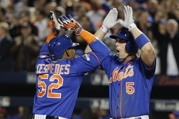 New York Mets' David Wright (5) greets Yoenis Cespedes (52) after Cespedes hit a two-run home run against the Los Angeles Dodgers during the fourth inning of baseball's Game 3 of the National League Division Series, Monday, Oct. 12, 2015, in New York. (AP Photo/Julie Jacobson)