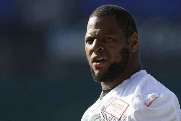 Miami Dolphins' defensive tackle Ndamukong Suh looks across the pitch during a training session Allianz Park in London, Friday Oct. 2, 2015. The Dolphins are preparing for an NFL football game against the New York Jets at London's Wembley stadium on Sunday. (AP Photo/Tim Ireland)