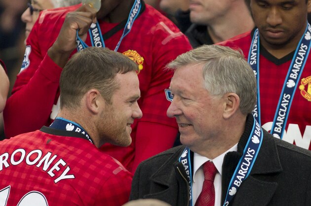 Manchester United's manager Sir Alex Ferguson, right, speaks to striker Wayne Rooney after his last home game in charge of the club, their English Premier League soccer match against Swansea, at Old Trafford Stadium, Manchester, England, Sunday May 12, 2013. (AP Photo/Jon Super)