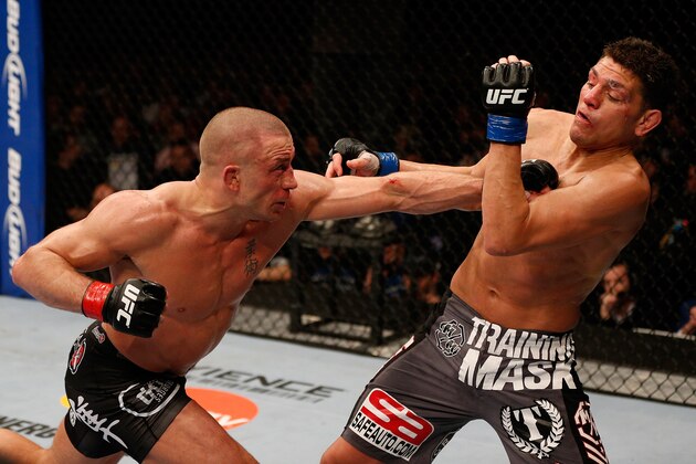 MONTREAL, QC - MARCH 16:  (L-R) Georges St-Pierre punches Nick Diaz in their welterweight championship bout during the UFC 158 event at Bell Centre on March 16, 2013 in Montreal, Quebec, Canada.  (Photo by Josh Hedges/Zuffa LLC/Zuffa LLC via Getty Images)