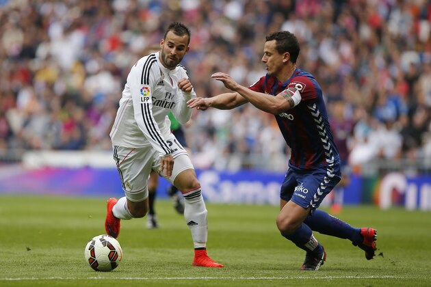Real Madrid's Jese Rodriguez, left, in action with Eibar Anibarro, right,  during a Spanish La Liga soccer match between Real Madrid and Eibar at the Santiago Bernabeu stadium in Madrid, Spain, Saturday, April 11, 2015. (AP Photo/Andres Kudacki)