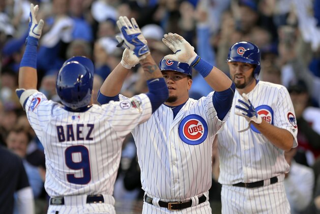 Chicago Cubs' Javier Baez (9) celebrates a three-run home run with Kyle Schwarber and Jason Hammel, right, of Game 4 in baseball's National League Division Series against the St. Louis Cardinals, Tuesday, Oct. 13, 2015, in Chicago. (AP Photo/Paul Beaty)
