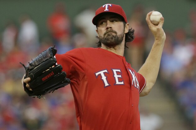 Texas Rangers starting pitcher Cole Hamels throws during the first inning of a baseball game against the Seattle Mariners in Arlington, Texas, Saturday, Sept. 19, 2015. (AP Photo/LM Otero)