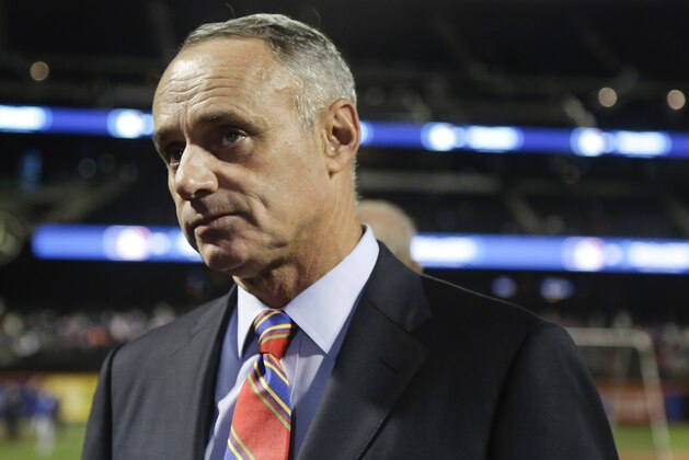 MLB commissioner Robert Manfred talks with members of the media and MLB personnel on the field before the start of baseball's Game 3 of the National League Division Series between the New York Mets and the Los Angeles Dodgers, Monday, Oct. 12, 2015, in New York. (AP Photo/Julie Jacobson)