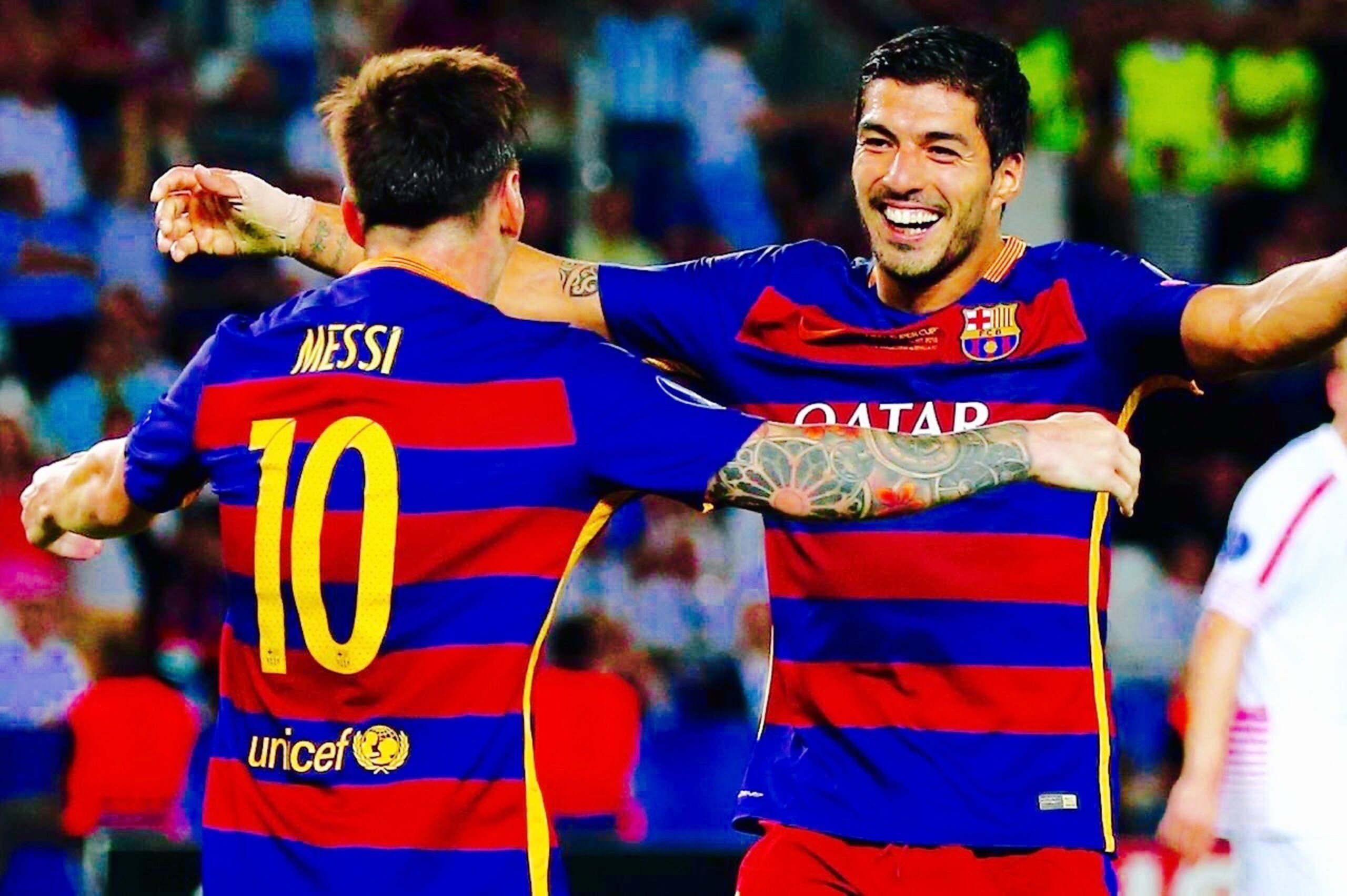 TBILISI, GEORGIA - AUGUST 11:  Lionel Messi of Barcelona celebrates with Luis Suarez of Barcelona after Rafinha of Barcelona (not pictured) scored their third goal during the UEFA Super Cup between Barcelona and Sevilla FC at Dinamo Arena on August 11, 2015 in Tbilisi, Georgia.  (Photo by Chris Brunskill/Getty Images)