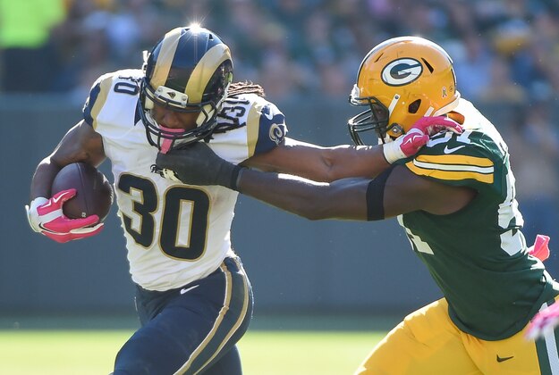 Oct 11, 2015; Green Bay, WI, USA; St. Louis Rams running back Todd Gurley (30) pushes away Green Bay Packers linebacker Nate Palmer (51) in the third quarter at Lambeau Field. Mandatory Credit: Benny Sieu-USA TODAY Sports