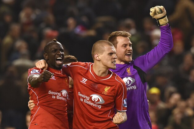 Liverpool's French defender Mamadou Sakho (L), Liverpool's Slovakian defender Martin Skrtel (C) and Liverpool's Belgian goalkeeper Simon Mignolet (R) celebrate their victory after the final whistle in the English Premier League football match between Liverpool and Tottenham Hotspur at the Anfield stadium in Liverpool, northwest England, on February 10, 2015.  AFP PHOTO / PAUL ELLIS

RESTRICTED TO EDITORIAL USE. No use with unauthorized audio, video, data, fixture lists, club/league logos or live services. Online in-match use limited to 45 images, no video emulation. No use in betting, games or single club/league/player publications.        (Photo credit should read PAUL ELLIS/AFP/Getty Images)