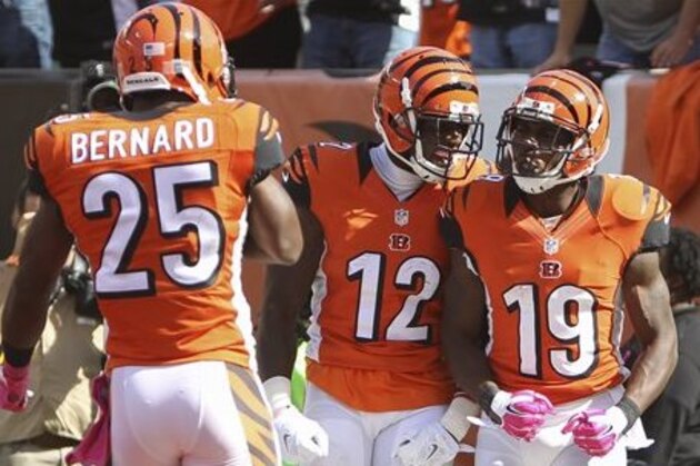 Cincinnati Bengals wide receiver Brandon Tate (19) celebrates after scoring a touchdown with wide receiver Mohamed Sanu (12) and running back Giovani Bernard (25) in the second half of an NFL football game against the Kansas City Chiefs, Sunday, Oct. 4, 2015, in Cincinnati. (AP Photo/Frank Victores)