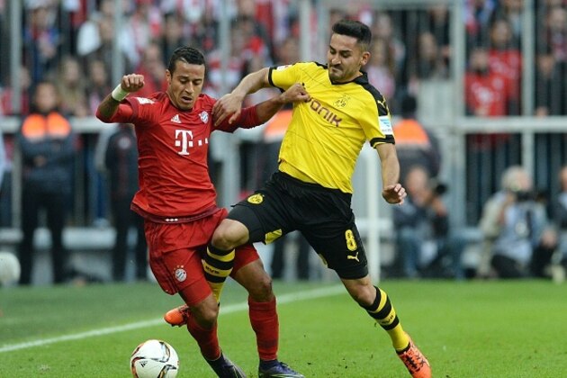 Bayern Munich's Spanish midfielder Thiago Alcantara (L) and Dortmund's midfielder Ilkay Guendogan (R) vie for the ball during the German first division Bundesliga football match FC Bayern Munich vs Borussia Dortmund in Munich, southern Germany, on October 4, 2015.  AFP PHOTO / CHRISTOF STACHE


RESTRICTIONS: DURING MATCH TIME: DFL RULES TO LIMIT THE ONLINE USAGE TO 15 PICTURES PER MATCH AND FORBID IMAGE SEQUENCES TO SIMULATE VIDEO. 
== RESTRICTED TO EDITORIAL USE ==
FOR FURTHER QUERIES PLEASE CONTACT DFL DIRECTLY AT + 49 69 650050.        (Photo credit should read CHRISTOF STACHE/AFP/Getty Images)