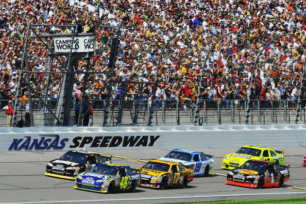 Drivers take the green flag at the start of the NASCAR Camping World RV 400 Sprint Cup Series auto race at Kansas Speedway in Kansas City, Kan., Sunday, Sept. 28, 2008. Jimmie Johnson (48) leads the field. (AP Photo/Larry Smith)