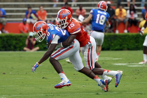Apr 11, 2015; Gainesville, FL, USA; Florida Gators running back Darius Masline (20) runs with the ball as defensive back Deiondre Porter (15) defends during the second half at the Orange and Blue Debut at Ben Hill Griffin Stadium. Orange defeated Blue 31-6. Mandatory Credit: Kim Klement-USA TODAY Sports