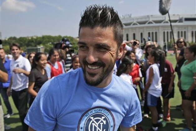 THIS CORRECTS THAT VILLA PLAYED FOR SPAIN, NOT BRAZIL - FILE -  In this July 31, 2014, file photo, David Villa, who will play for the MLS expansion New York City soccer team,  plays soccer with kids from the South Bronx United program in front of Yankee Stadium in New York. Villa is the all-time leading Spanish National Team scorer. He scored five goals as Spain won the 2010 World Cup.  (AP Photo/Seth Wenig, File)