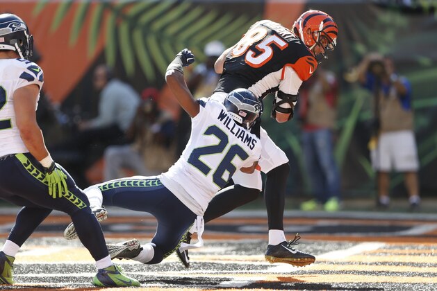Cincinnati Bengals tight end Tyler Eifert (85) scores a touchdown against Seattle Seahawks cornerback Cary Williams (26) in the second half of an NFL football game, Sunday, Oct. 11, 2015, in Cincinnati. (AP Photo/Gary Landers)