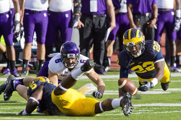 Michigan safety Jarrod Wilson (22) dives trying to catch a pass deflected by defensive back Jabrill Peppers (5), intended for Northwestern wide receiver Mike McHugh (6), in the second quarter of an NCAA college football game in Ann Arbor, Mich., Saturday, Oct. 10, 2015. (AP Photo/Tony Ding)
