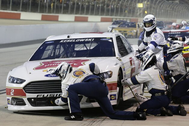 Crew members for Brad Keselowski perform a pit stop during a NASCAR Sprint Cup auto race at Darlington Raceway in Darlington, S.C., Sunday, Sept. 6, 2015. (AP Photo/Terry Renna)