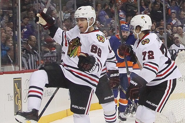 NEW YORK, NY - OCTOBER 09:  Patrick Kane #88 of the Chicago Blackhawks (l) scores at 15:11 of the second period against the New York Islanders at the Barclays Center on October 9, 2015 in Brooklyn borough of New York City. The game is the first for the Islanders in their new arena.  The Blackhawks defeated the Islanders 3-2 in overtime. (Photo by Bruce Bennett/Getty Images)