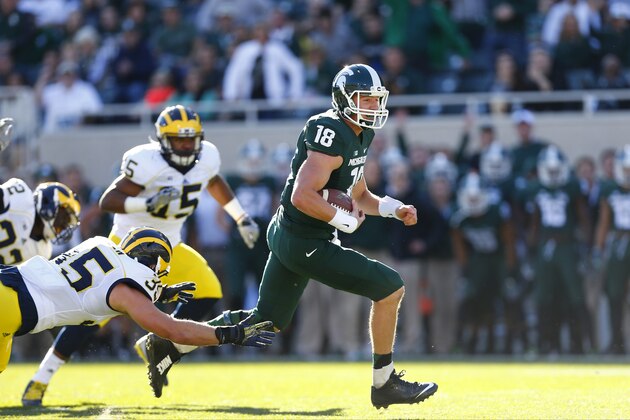 EAST LANSING, MI - OCTOBER 25: Connor Cook #18 of the Michigan State Spartans rush for a first down in the first quarter against the Michigan Wolverines at Spartan Stadium on October 25 , 2014 in East Lansing, Michigan. (Photo by Rey Del Rio/Getty Images)