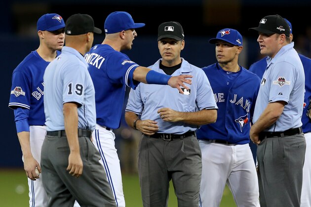 TORONTO, ON - OCTOBER 14:  Troy Tulowitzki #2 of the Toronto Blue Jays argues a call in seventh inning with the umpires as the Texas Rangers score a run after the throw by Russell Martin #55 of the Toronto Blue Jays hits the bat of Shin-Soo Choo #17 of the Texas Rangers in game five of the American League Division Series at Rogers Centre on October 14, 2015 in Toronto, Canada.  (Photo by Vaughn Ridley/Getty Images)