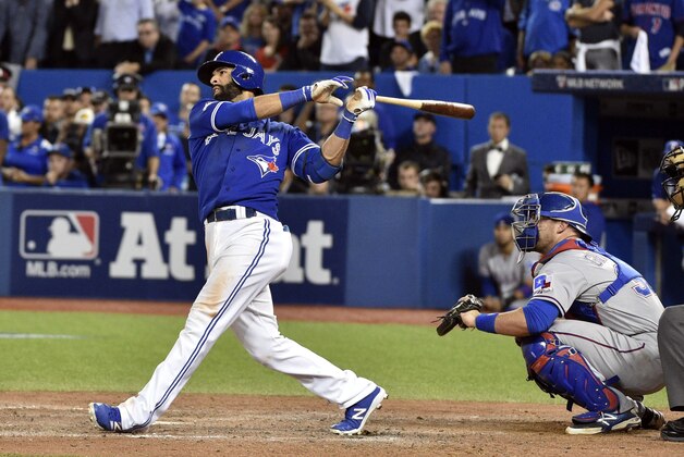 Oct 14, 2015; Toronto, Ontario, CAN; Toronto Blue Jays right fielder Jose Bautista (19) hits a home run during the seventh inning against the Texas Rangers in game five of the ALDS at Rogers Centre. Mandatory Credit: Nick Turchiaro-USA TODAY Sports
