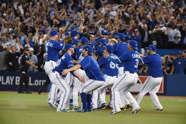 Oct 14, 2015; Toronto, Ontario, CAN; Toronto Blue Jays players celebrate on the field after defeating the Texas Rangers in game five of the ALDS at Rogers Centre. Mandatory Credit: Dan Hamilton-USA TODAY Sports